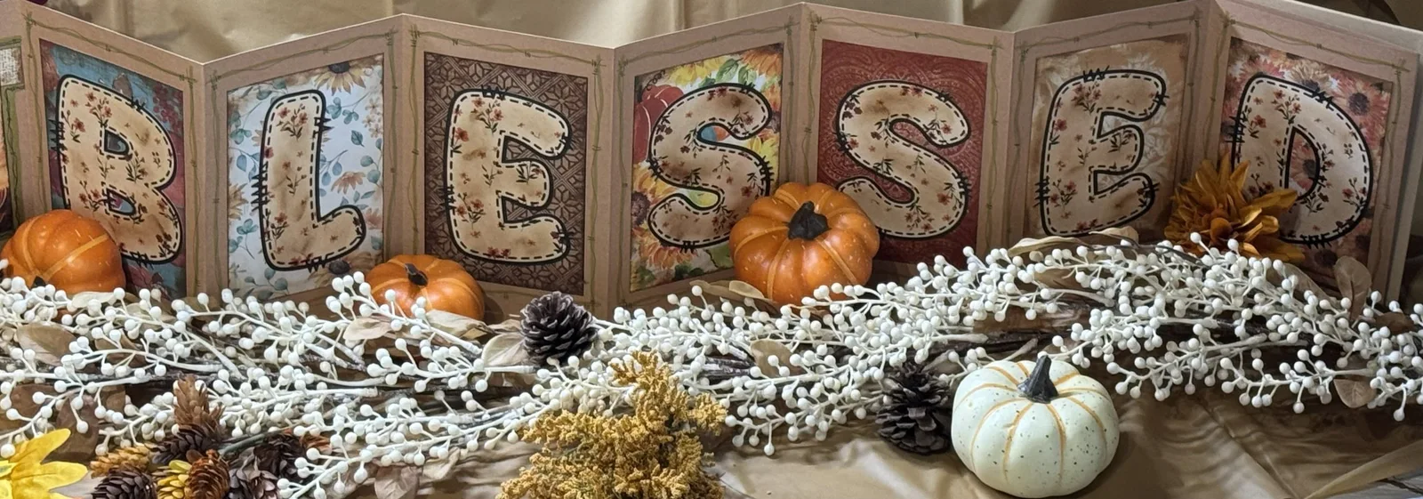 Handmade autumn accordion display spelling Blessed.