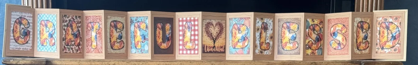 Handmade accordion display spelling Grateful and Blessed.