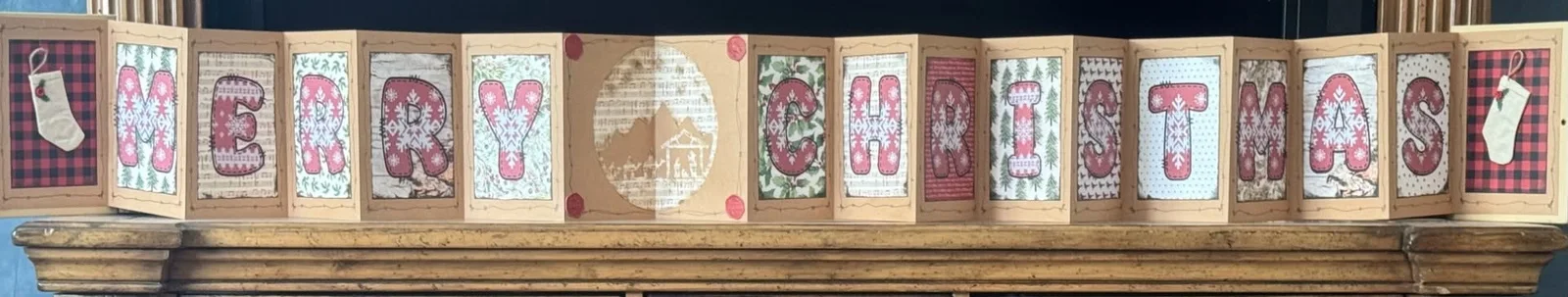 Handmade accordion display spelling Merry Christmas.